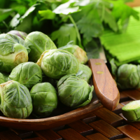 fresh raw brussels sprouts on a wooden table and knife