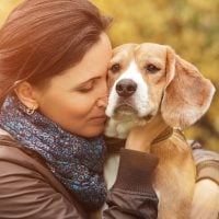 Woman and her favorite dog portrait hugging outdoors