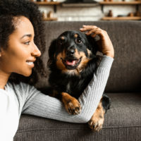 woman hugging dog in house