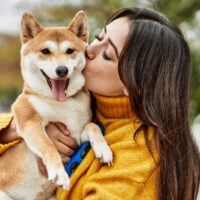 woman kissing her dog