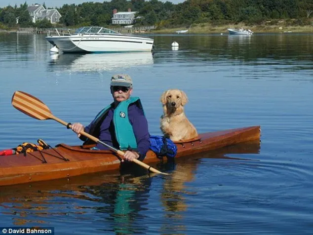 man and a dog in kayak