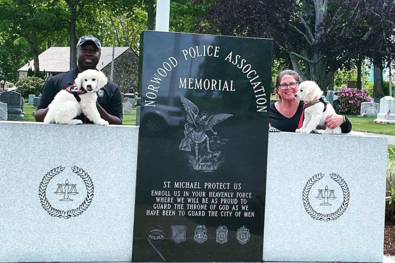 two puppies on police monument in cemetery