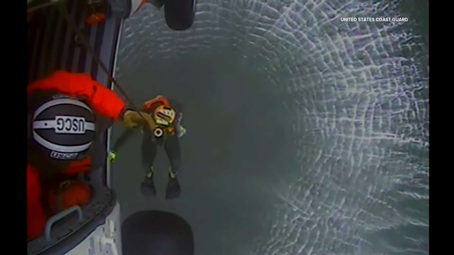 a rescue swimmer lowered into the water