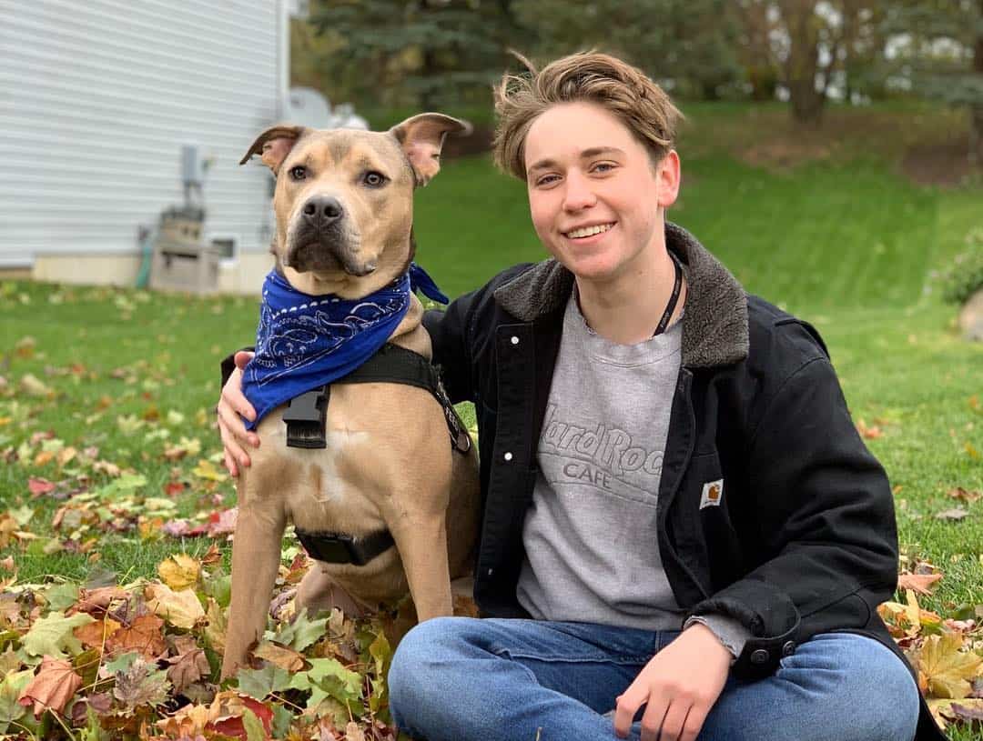 hedgie the dog and his owner posing for a photo