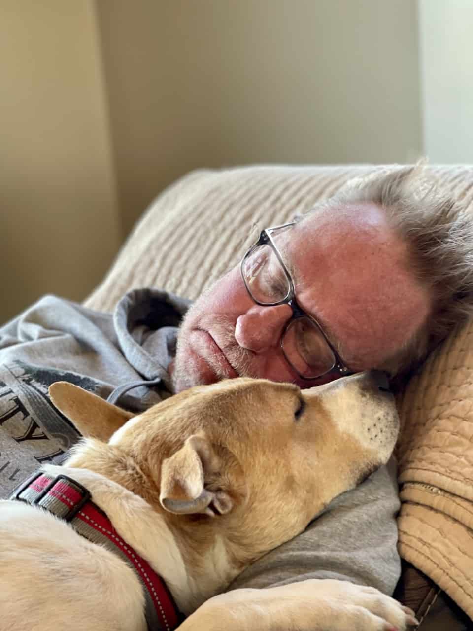 man sleeping with dog