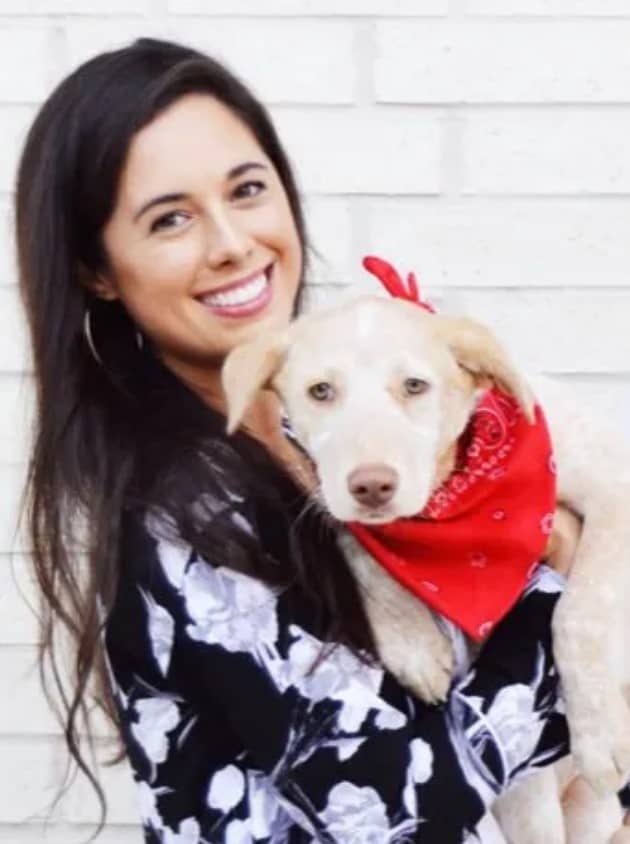 smiling woman holding dog