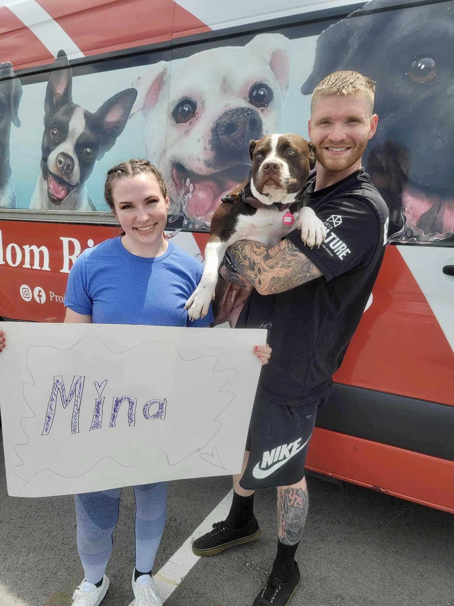 owners with their adopted dog