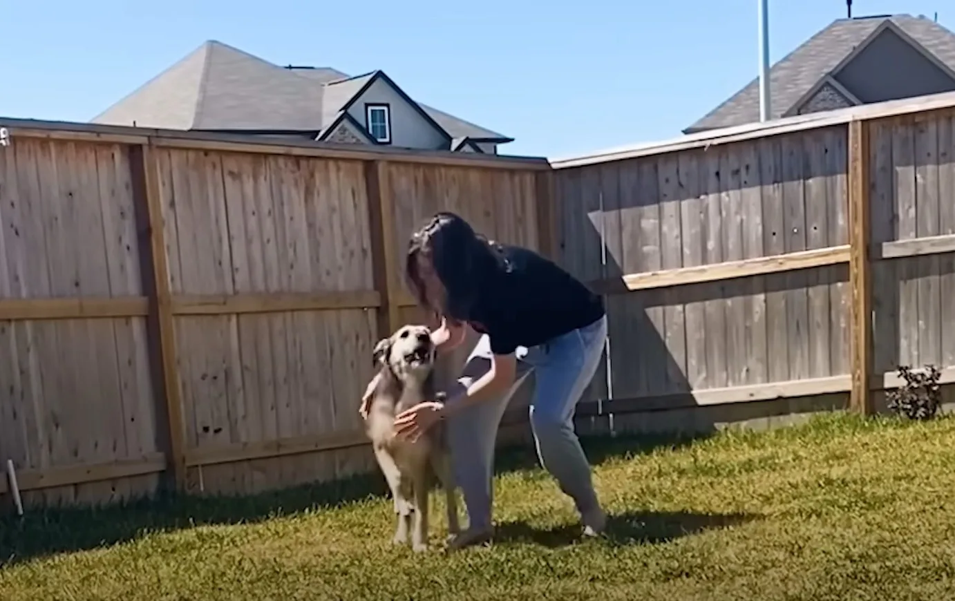 woman with dog in the yard