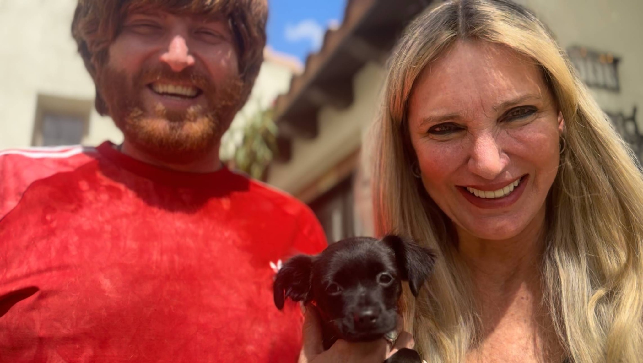 Couple and cute black puppy