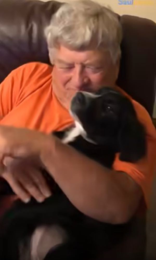 old guy holding a dog