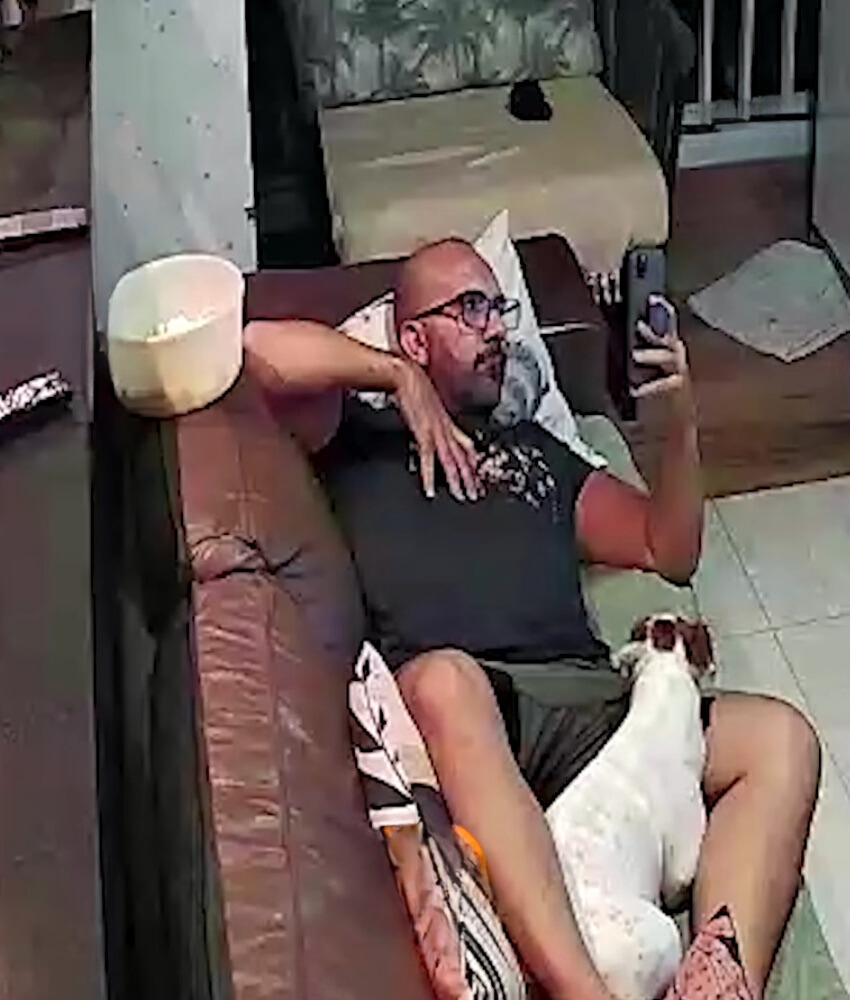 owner and dog laying on the couch