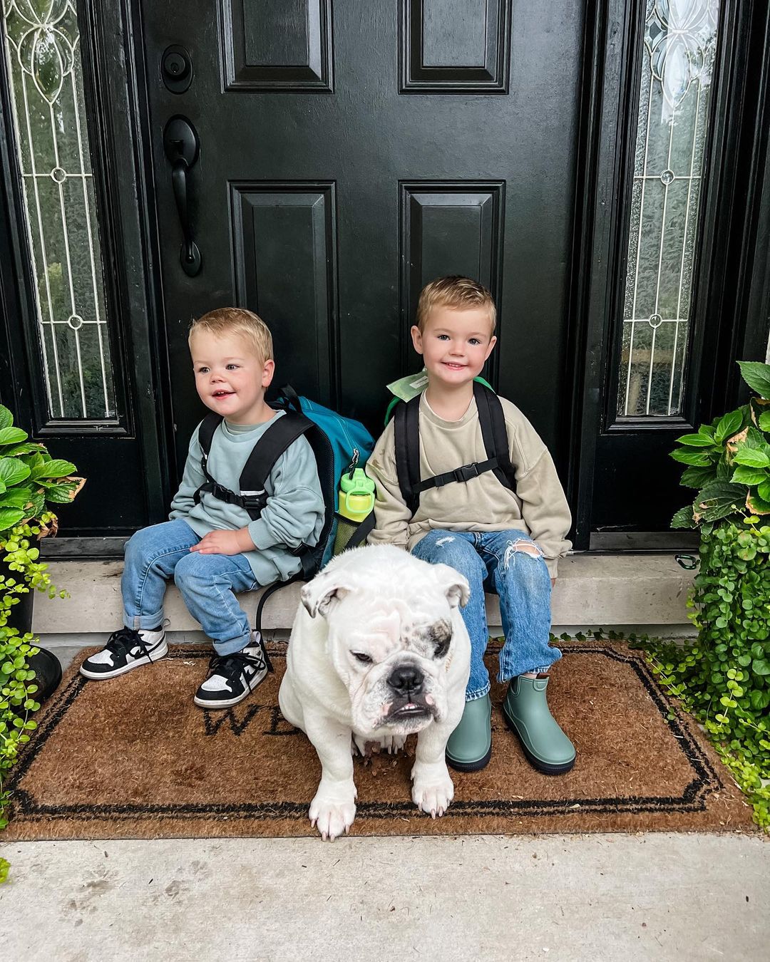 photo of two little boys and bulldog sitting on front porch