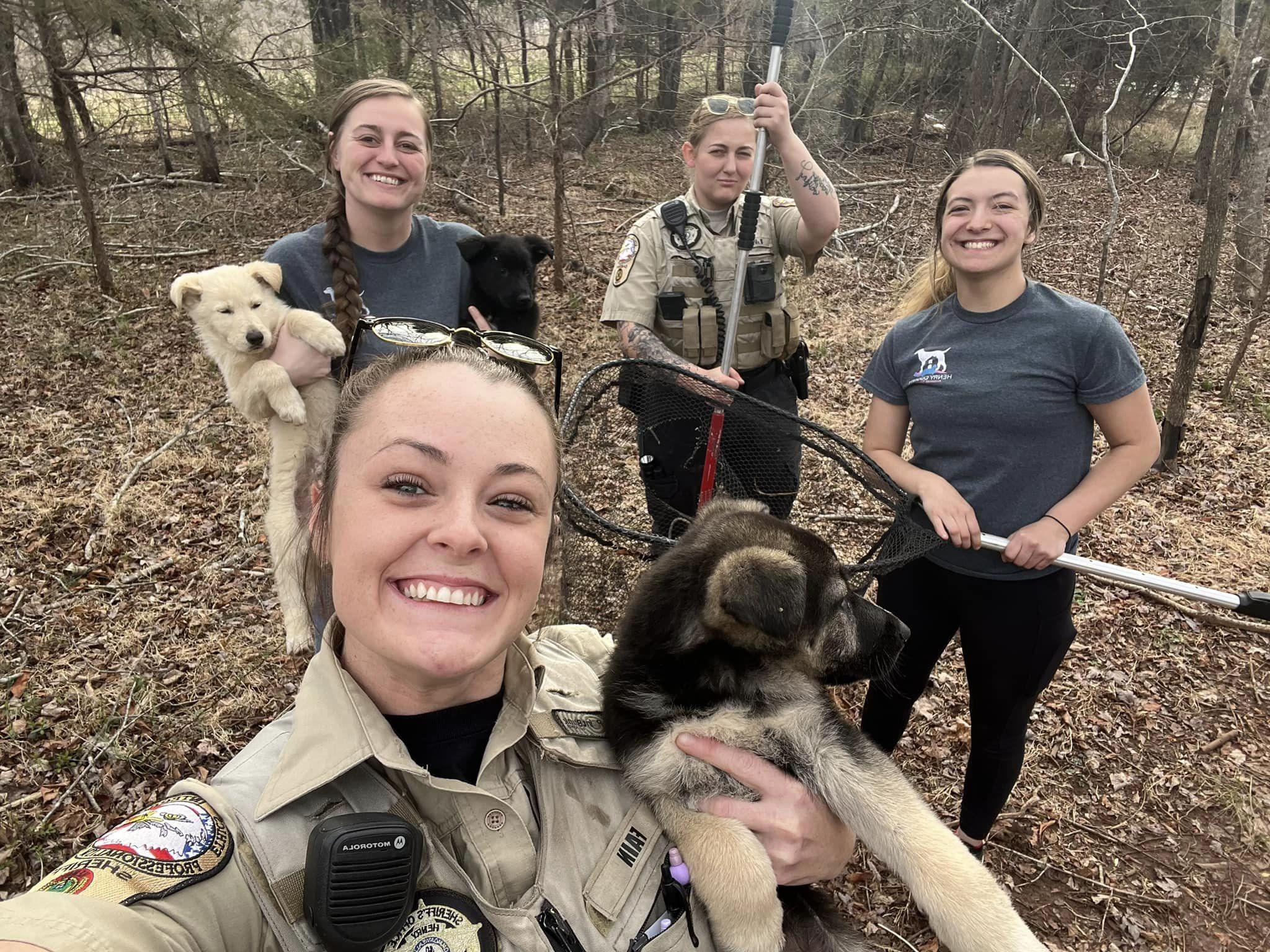 women rescuers with puppies