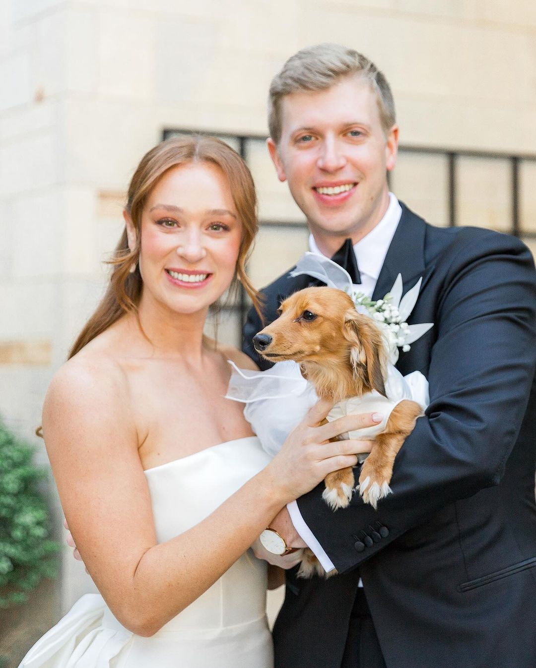 bride and the groom posing with dog