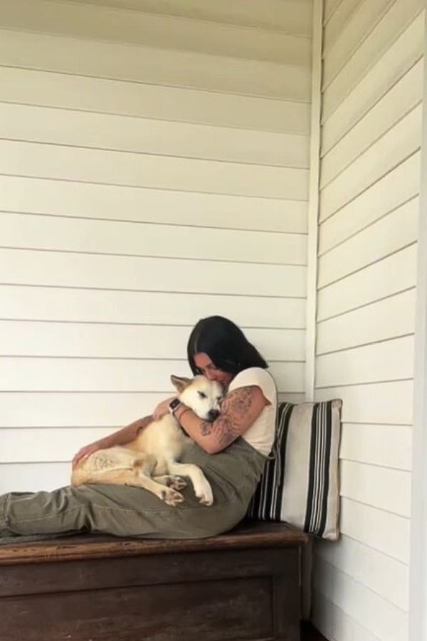 woman and dog cuddling