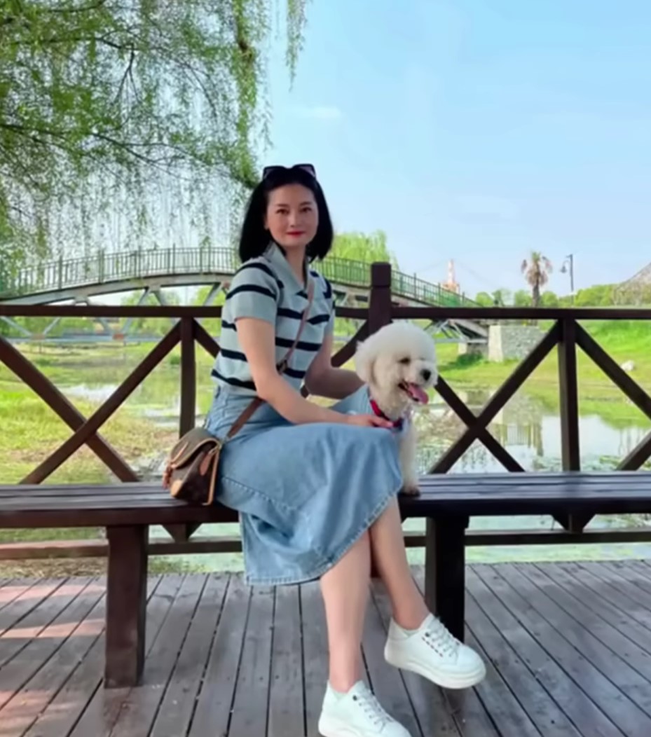 woman and dog sitting at the park