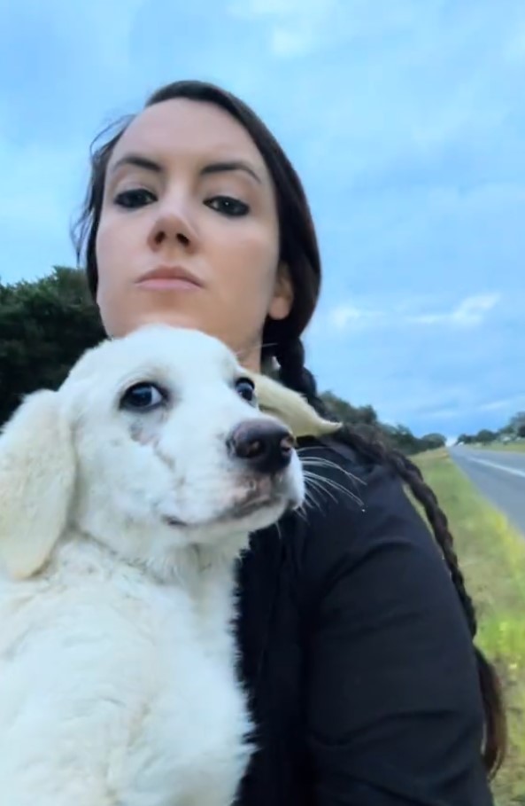 woman carrying a puppy