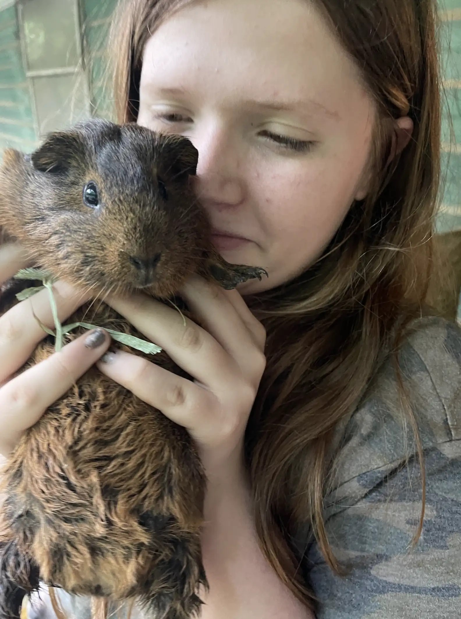 woman holding a guinea pig