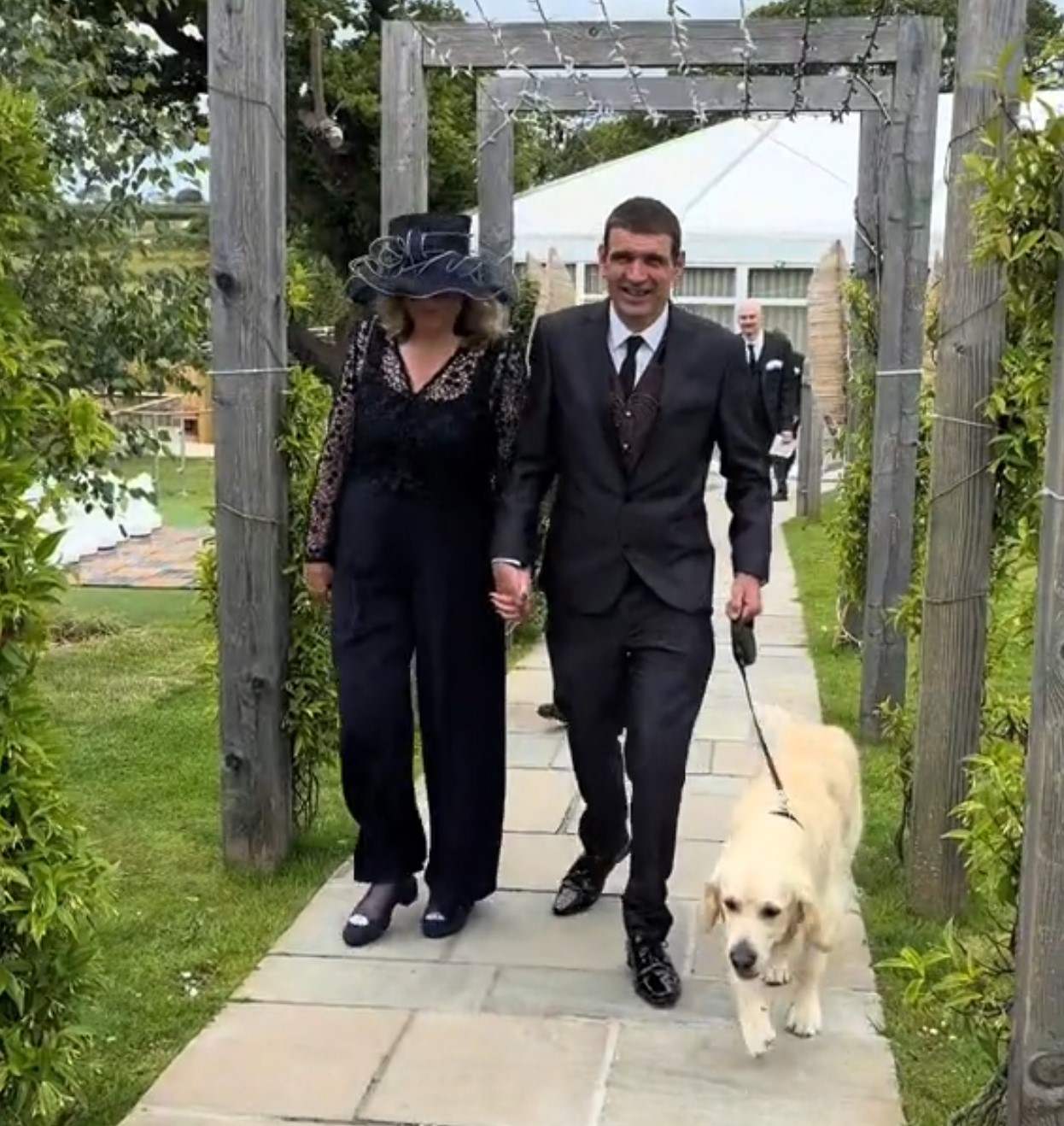 man and woman walking with a dog