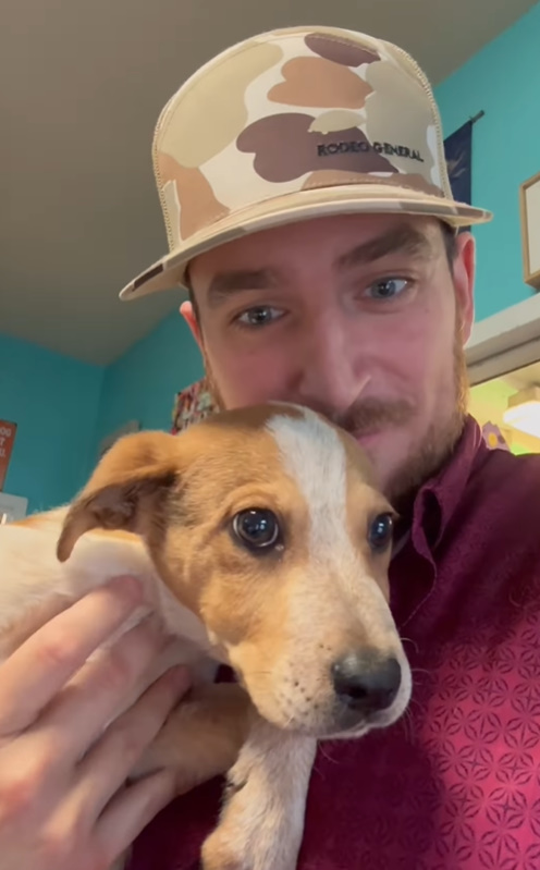 man posing with his adopted dog