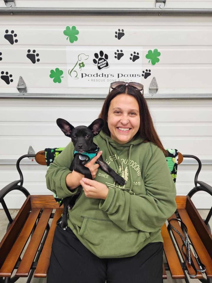 smiling woman posing with dog with big ears