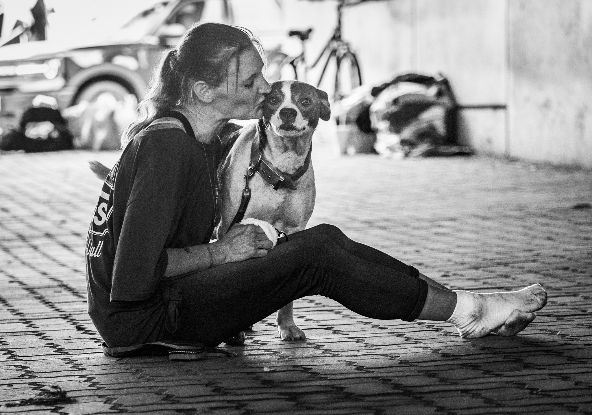 woman kissing a dog