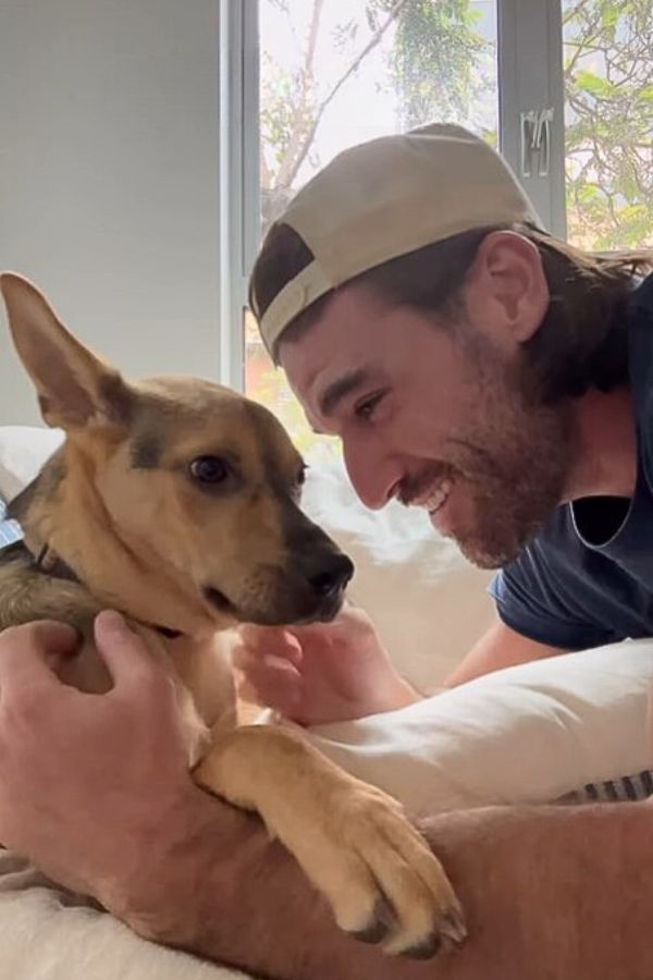 guy with cap and dog