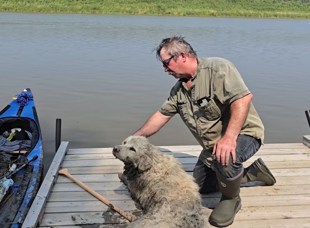 man with muddy dog