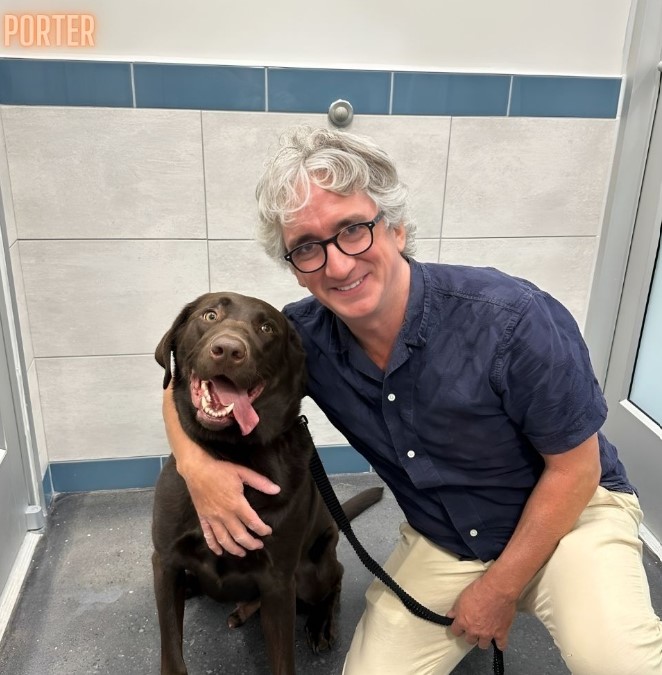 a delighted dog with its new owner as they take pictures