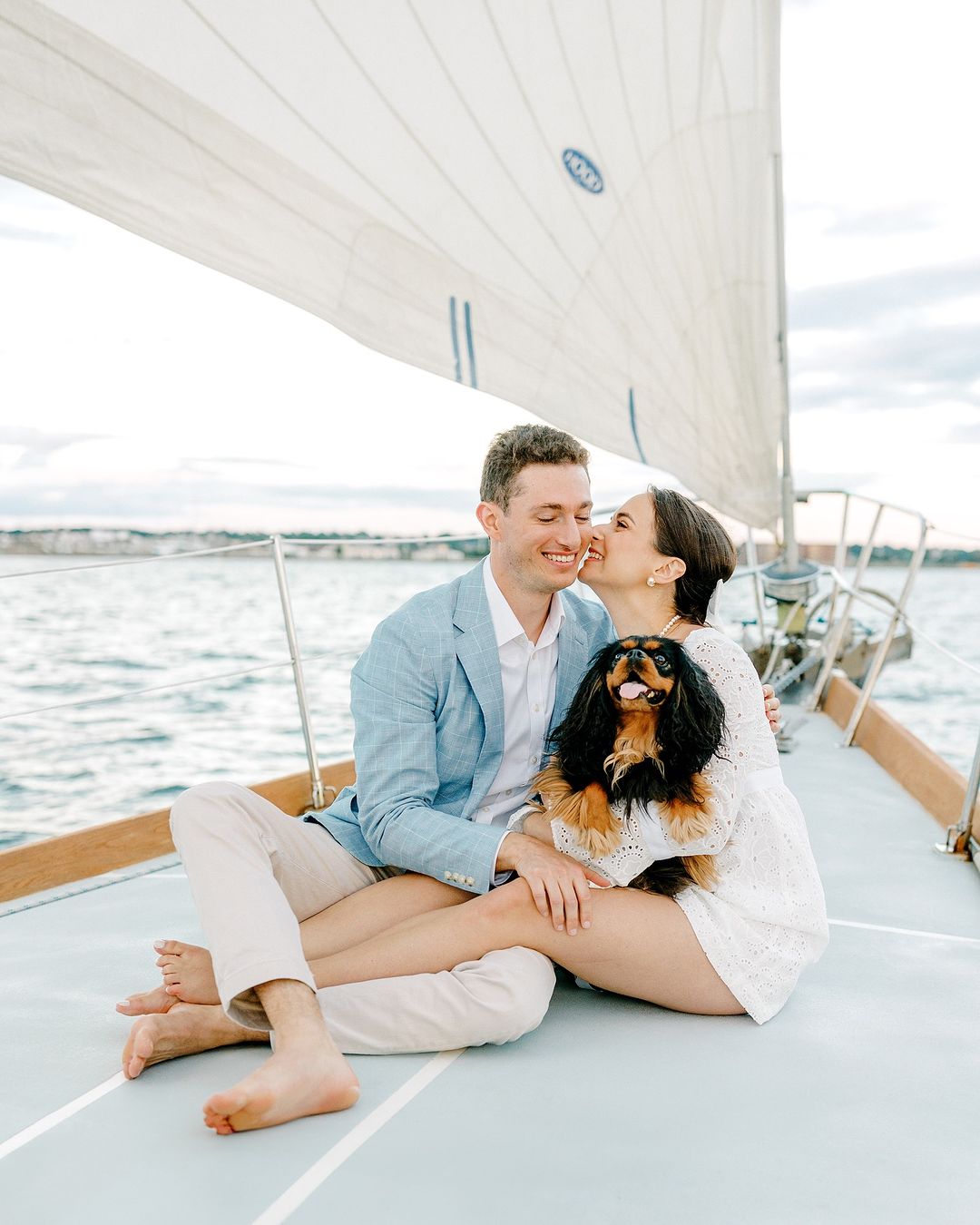 couple on a yacht with dog