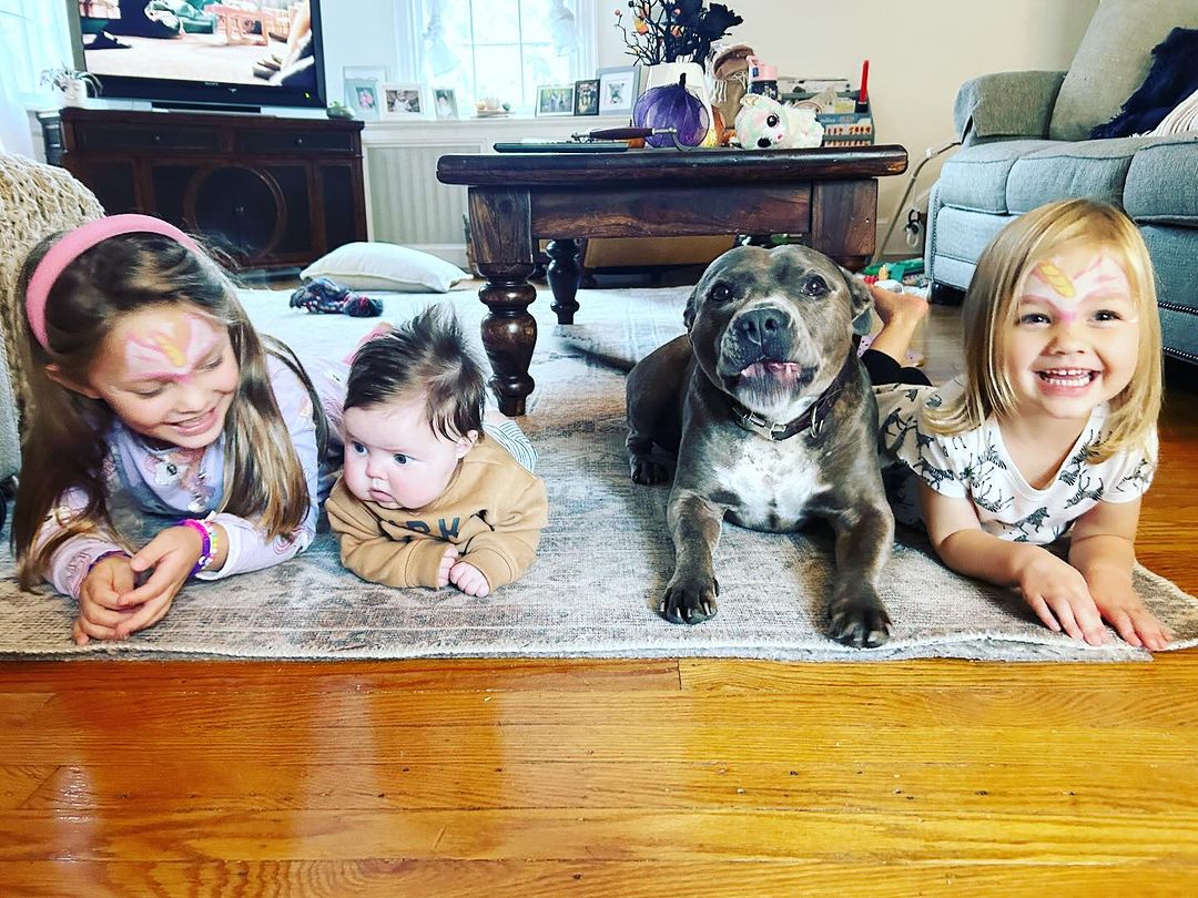 kids and dog laying down