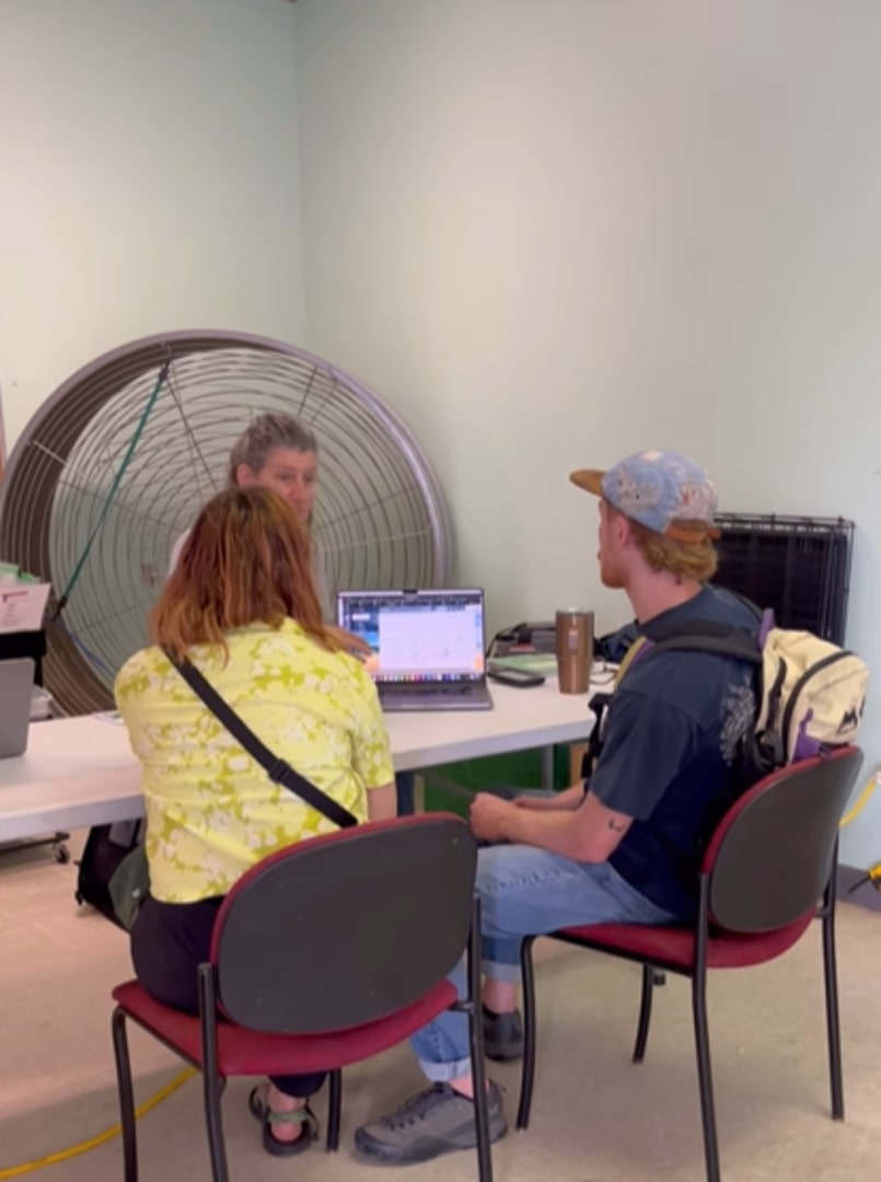 man and a woman sitting with woman for dog adoption