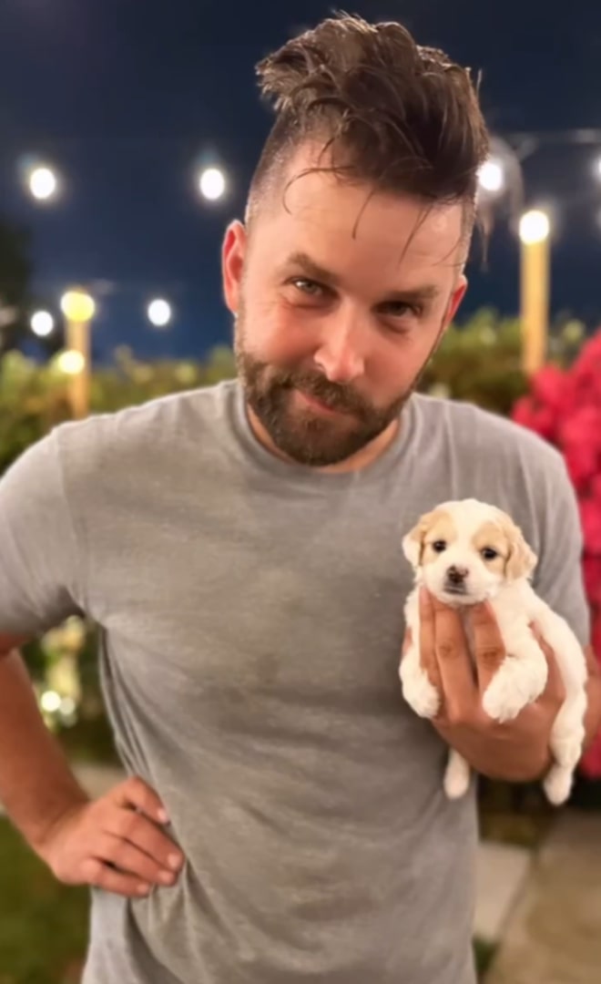 man holding a puppy