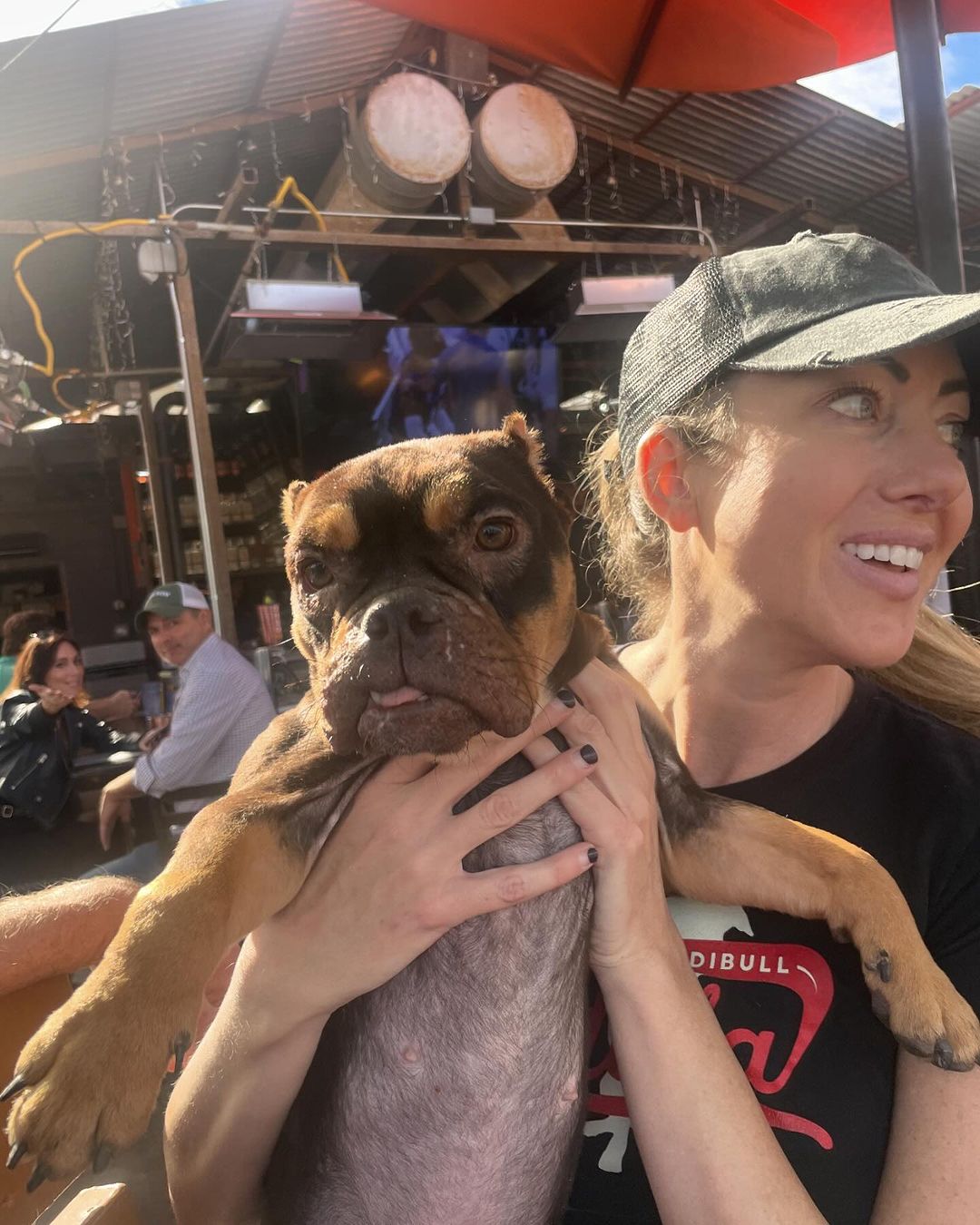 woman holding the pitbull