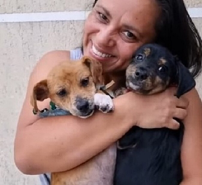 woman holding two dogs