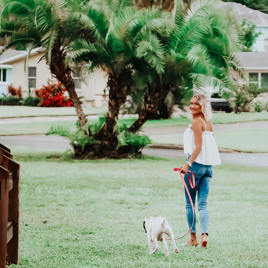 young woman walking with dog in the park