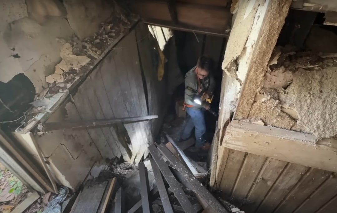 a man enters an abandoned house