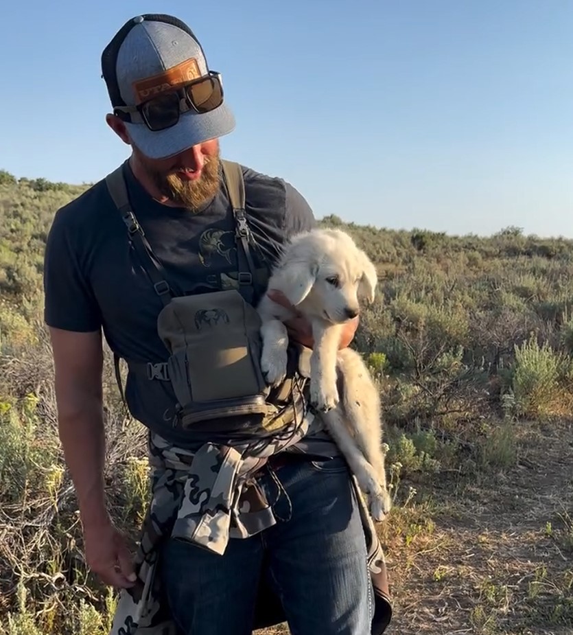 hiker holding a puppy