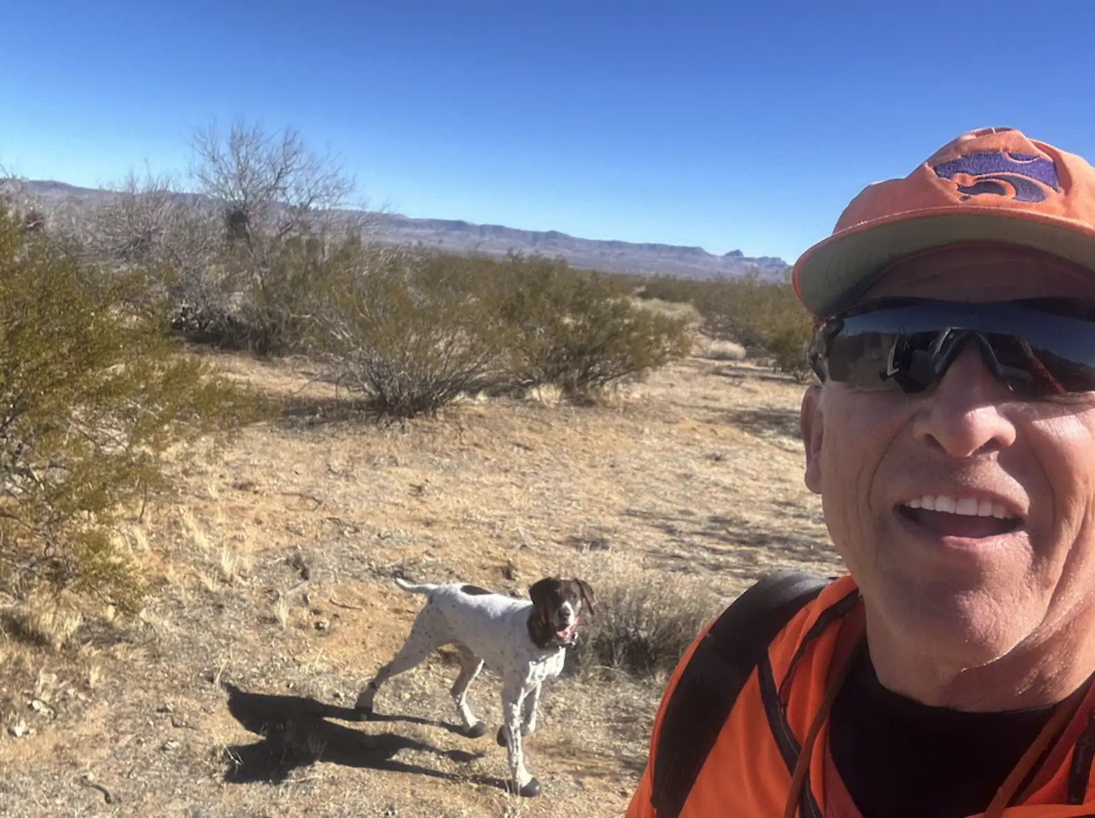 man and a dog hiking