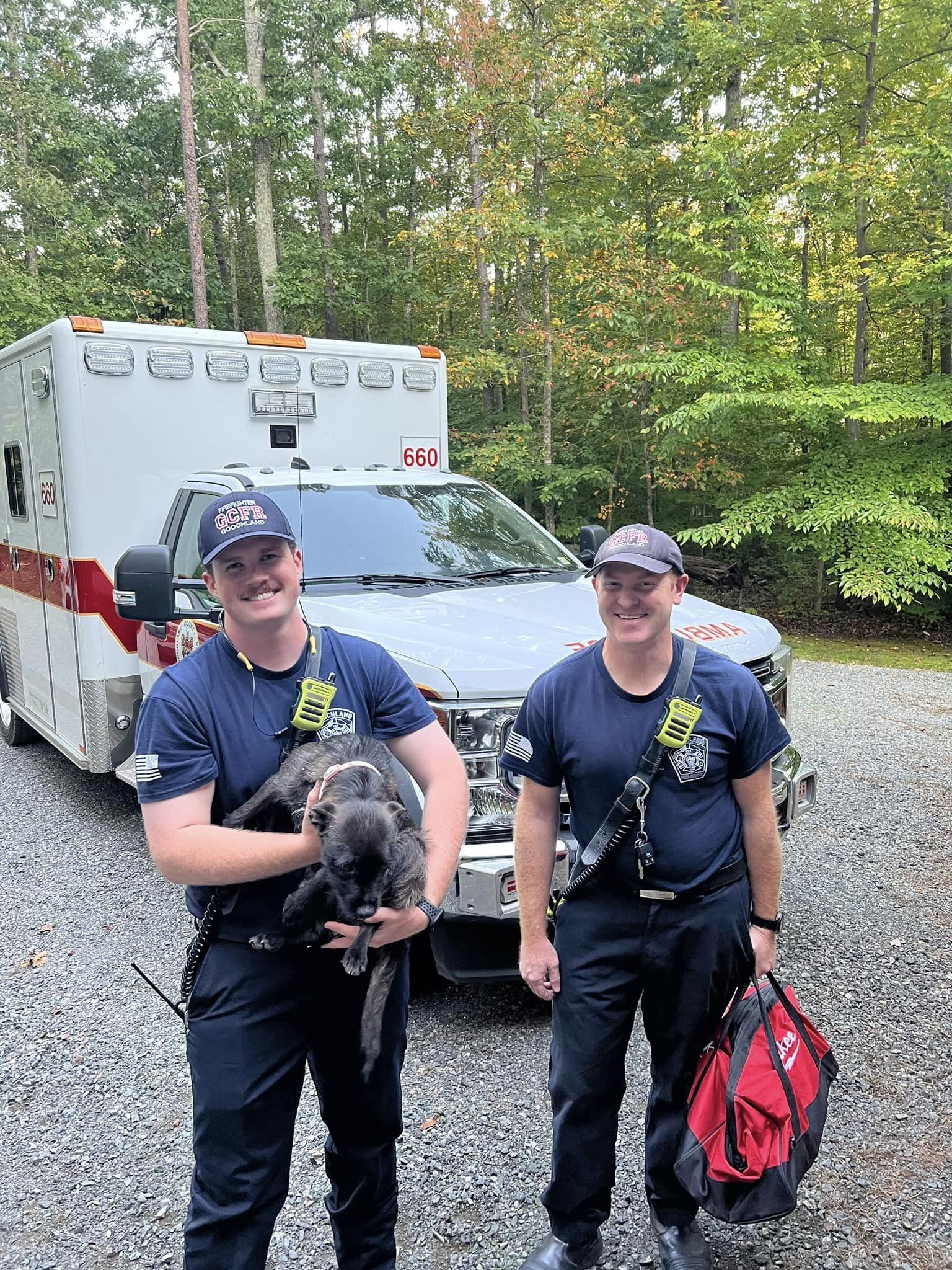 rescuers posing with dog