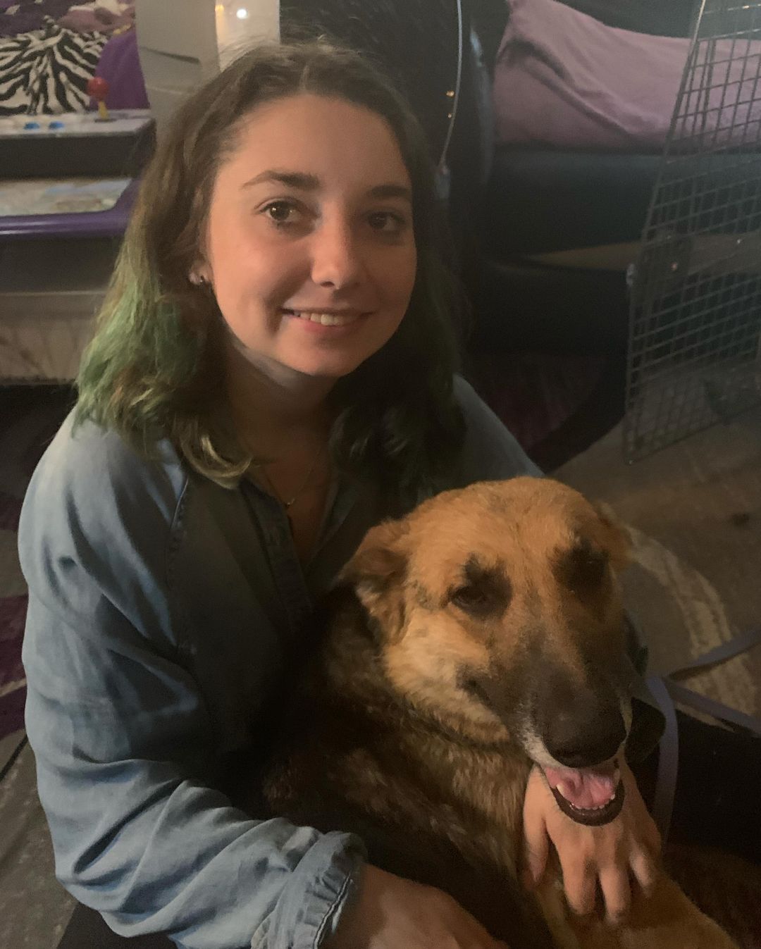 smiling woman sitting with dog