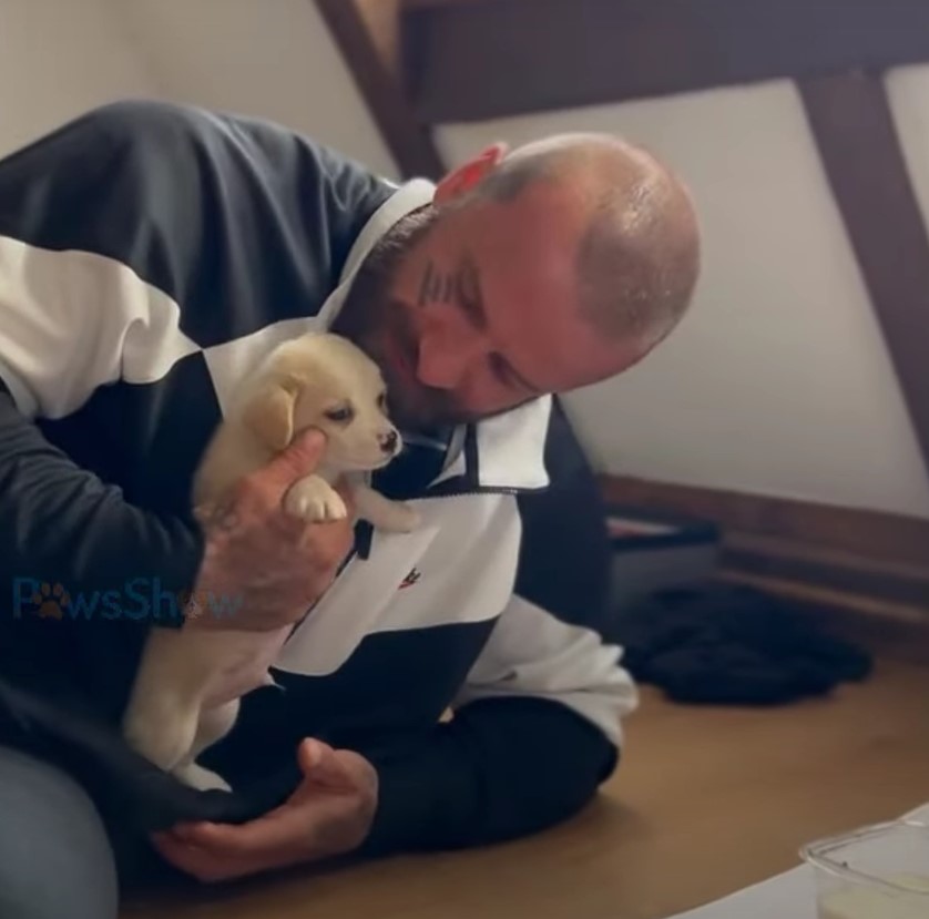 tattooed man with puppy