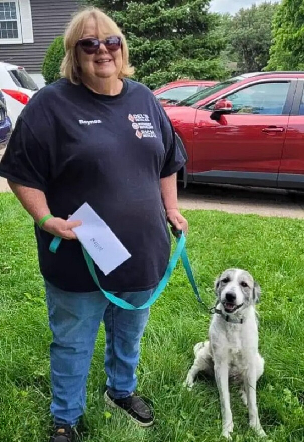 woman holding dog on a leash