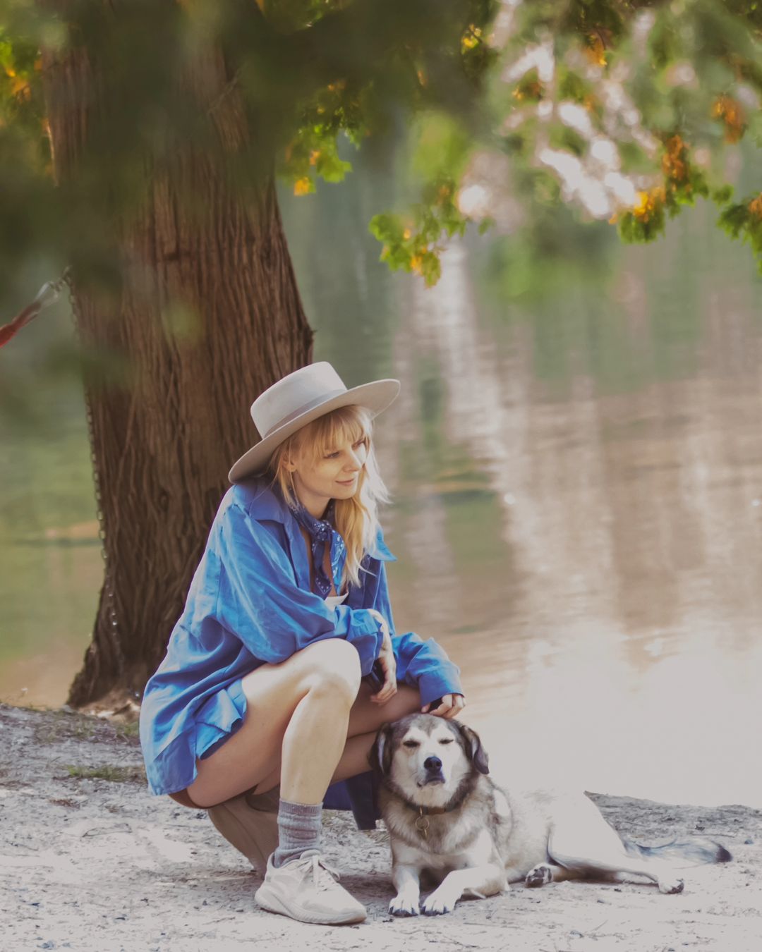 woman with dog by the lake