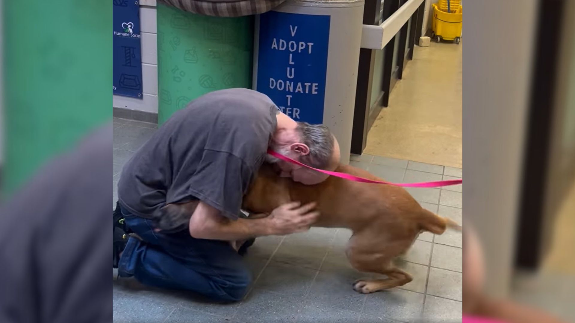 man and dog hugging