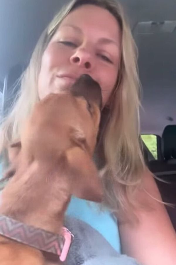 a dog licking womans face