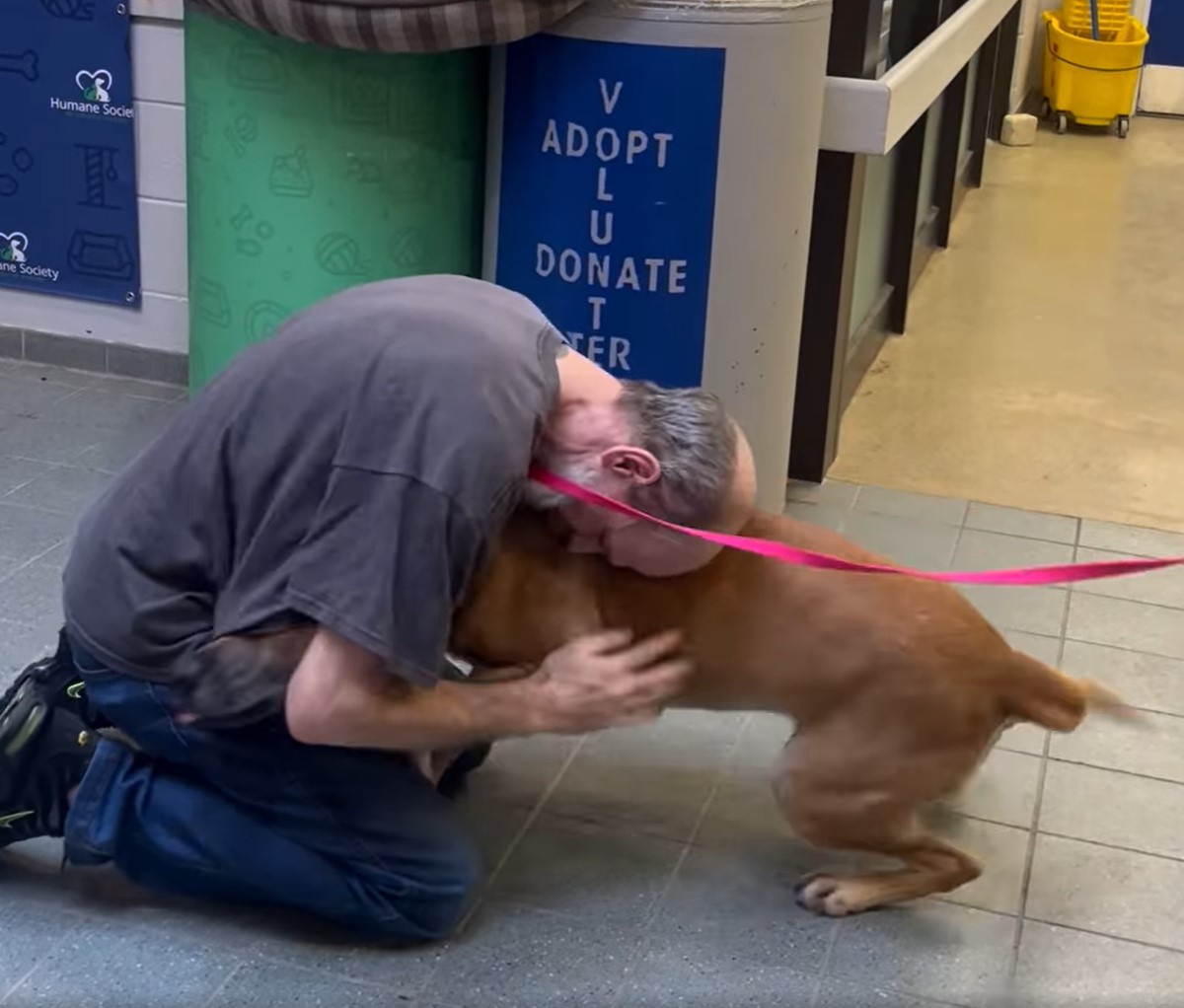 a man hugging with dog on his knee