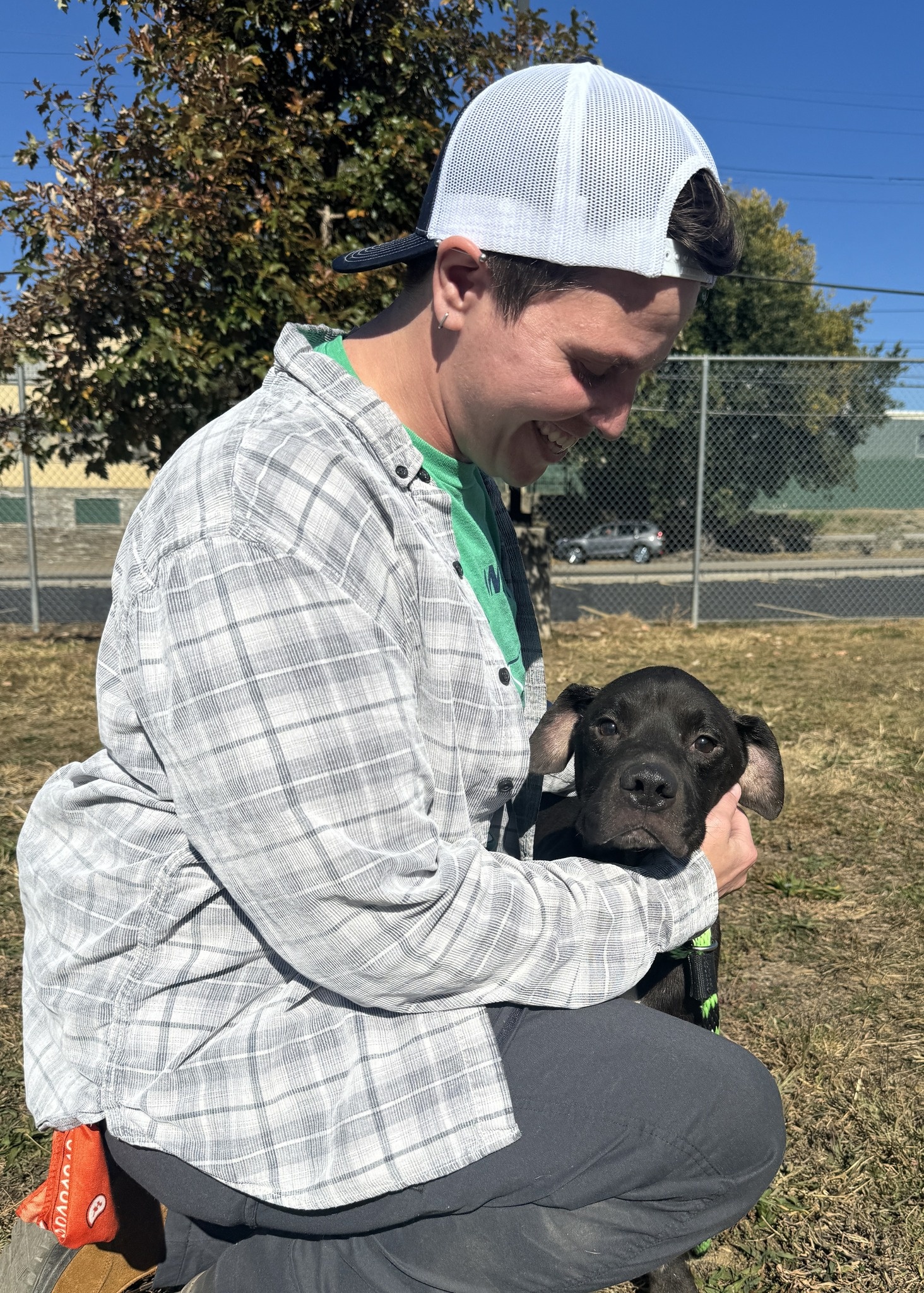 a man with black puppy outdoor