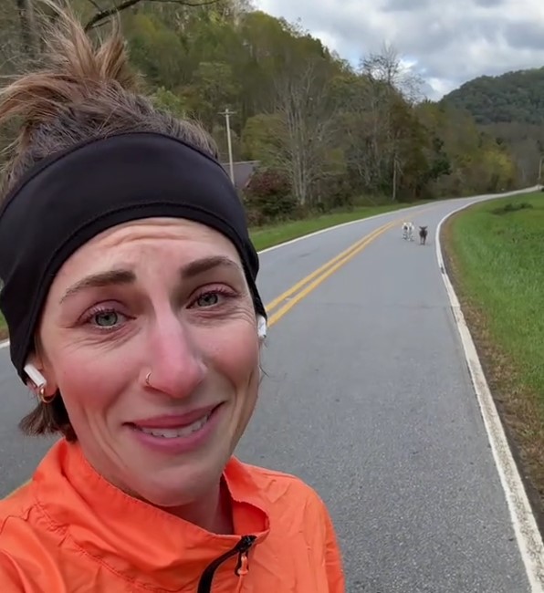 dogs running after woman