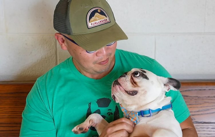 man and dog looking each other in the eyes